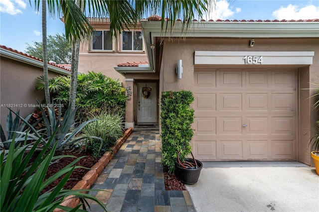 1654 SW 109th Ter, Davie, FL 33324 - view of front of home with a tiled roof, stucco siding, and driveway