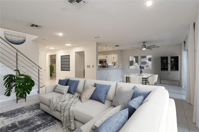 1654 SW 109th Ter, Davie, FL 33324 - living room with light tile patterned floors, ceiling fan, stairs, and recessed lighting