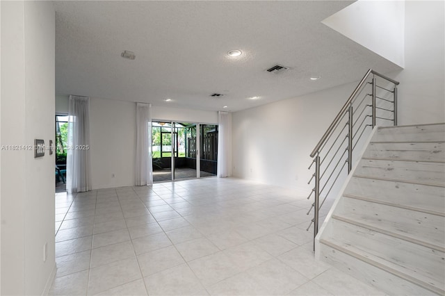 1654 SW 109th Ter, Davie, FL 33324 - empty room with a textured ceiling, recessed lighting, stairway, and light tile patterned floors