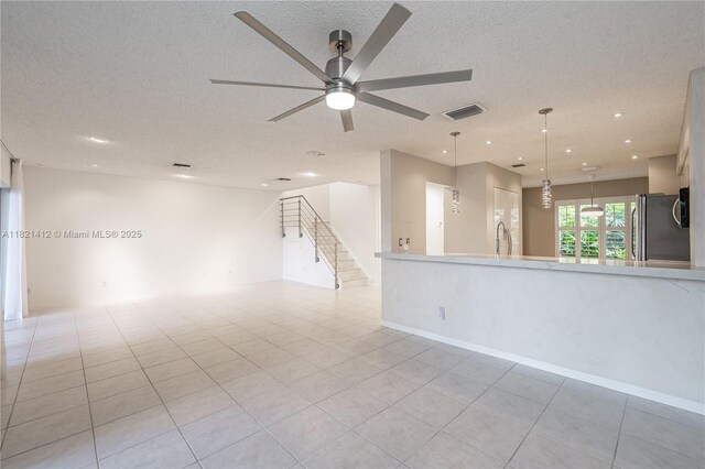 1654 SW 109th Ter, Davie, FL 33324 - unfurnished room with a ceiling fan, stairs, a textured ceiling, recessed lighting, and light tile patterned floors