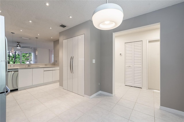 1654 SW 109th Ter, Davie, FL 33324 - kitchen featuring stainless steel dishwasher, white cabinets, light countertops, decorative light fixtures, and a textured ceiling