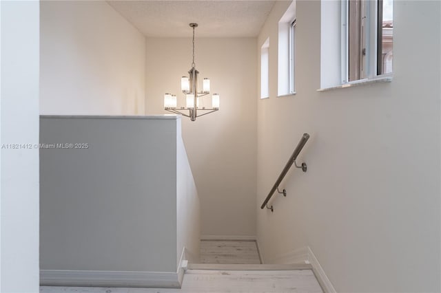 1654 SW 109th Ter, Davie, FL 33324 - stairs with a chandelier, wood finished floors, and a textured ceiling