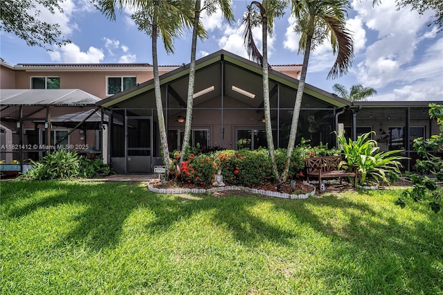 1654 SW 109th Ter, Davie, FL 33324 - back of property featuring stucco siding, a lawn, and a lanai