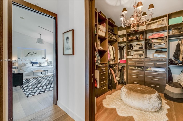 2000 S Bayshore Dr Unit 47, Miami, FL 33133 - spacious closet featuring wood finished floors, a chandelier, and lofted ceiling