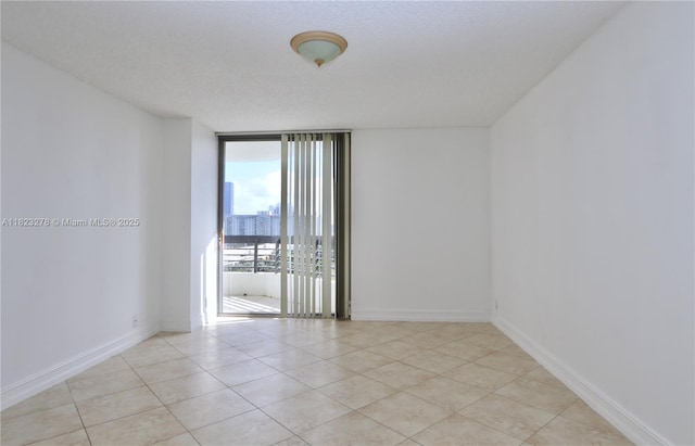 3500 Mystic Pointe Dr Unit 1207, Aventura, FL 33180 - empty room featuring expansive windows and light tile patterned floors