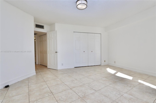 3500 Mystic Pointe Dr Unit 1207, Aventura, FL 33180 - unfurnished bedroom with a closet and light tile patterned floors
