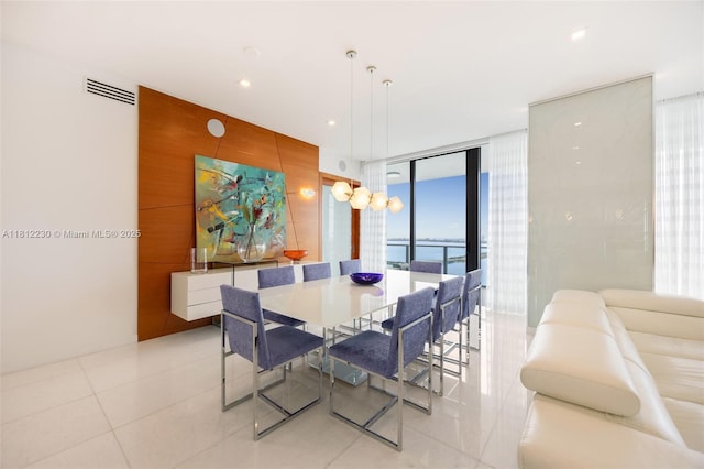 480 NE 31st St Unit 3802, Miami, FL 33137 - dining area with expansive windows, a water view, light tile patterned floors, and an accent wall