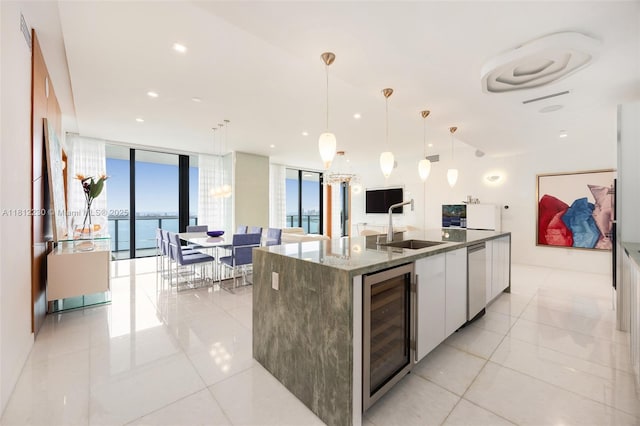 480 NE 31st St Unit 3802, Miami, FL 33137 - kitchen with beverage cooler, modern cabinets, white cabinets, expansive windows, and light tile patterned floors