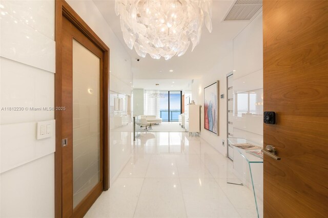 480 NE 31st St Unit 3802, Miami, FL 33137 - corridor featuring light tile patterned floors and a chandelier