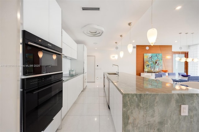 480 NE 31st St Unit 3802, Miami, FL 33137 - kitchen with modern cabinets, white cabinets, light tile patterned flooring, and stone counters