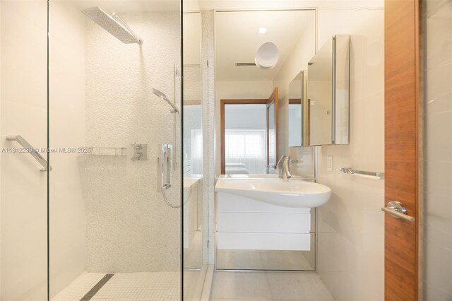 480 NE 31st St Unit 3802, Miami, FL 33137 - bathroom with a shower stall, vanity, and tile patterned floors