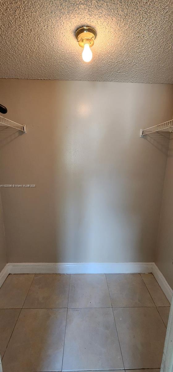14830 Naranja Lakes Blvd Unit A1B, Homestead, FL 33032 - spacious closet featuring light tile patterned flooring
