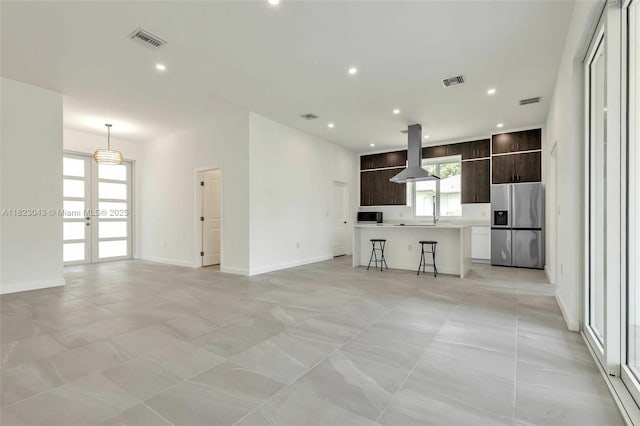 337 Jourferie Rd, Lehigh Acres, FL 33974 - unfurnished living room with french doors and recessed lighting