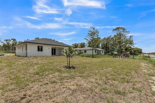 337 Jourferie Rd, Lehigh Acres, FL 33974 - view of green lawn featuring a playground