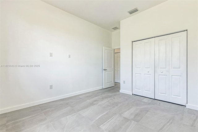 337 Jourferie Rd, Lehigh Acres, FL 33974 - unfurnished bedroom with baseboards and a closet