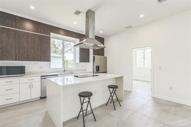 337 Jourferie Rd, Lehigh Acres, FL 33974 - kitchen featuring stainless steel appliances, island range hood, a kitchen bar, a center island, and light countertops
