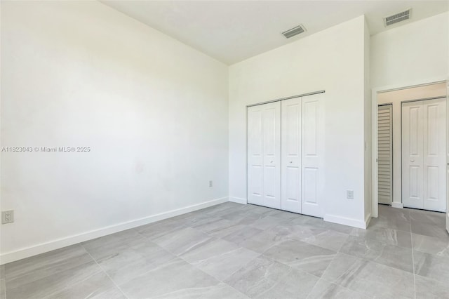337 Jourferie Rd, Lehigh Acres, FL 33974 - unfurnished bedroom with baseboards and a closet
