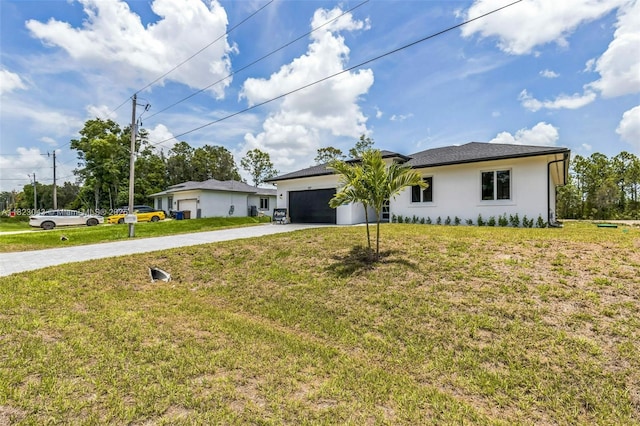 337 Jourferie Rd, Lehigh Acres, FL 33974 - view of front of house with driveway, a garage, stucco siding, and a front lawn