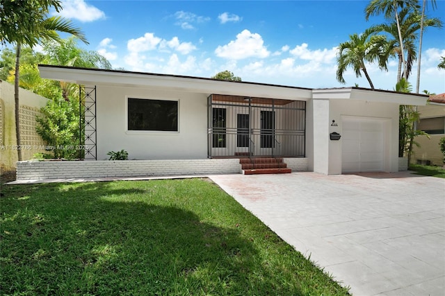 708 Navarre Ave, Coral Gables, FL 33134 - view of front of house with an attached garage, a front yard, driveway, and stucco siding