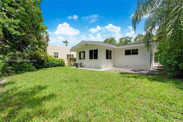 708 Navarre Ave, Coral Gables, FL 33134 - rear view of house with stucco siding, a patio area, and a yard