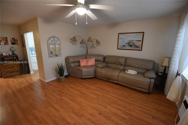 118 Brighton C 118, Boca Raton, FL 33434 - living room with light wood finished floors, a textured ceiling, and ceiling fan