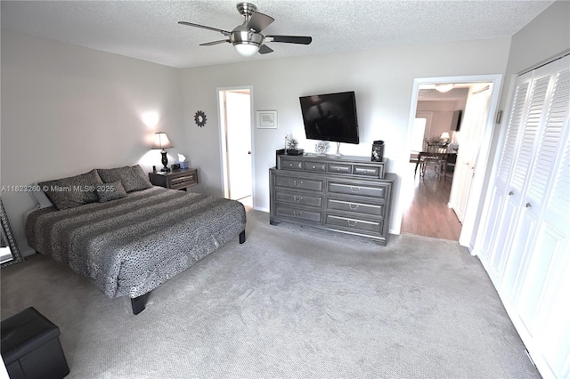 118 Brighton C 118, Boca Raton, FL 33434 - bedroom with carpet floors, a textured ceiling, a closet, and a ceiling fan