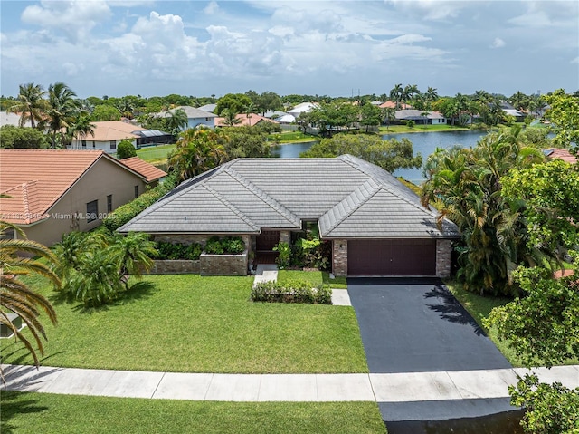 851 Altavista Ter, Davie, FL 33325 - view of front of property with a water view, a front lawn, an attached garage, asphalt driveway, and a residential view