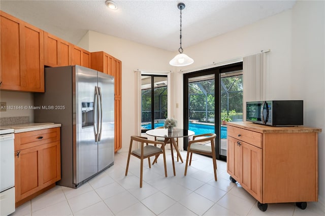 851 Altavista Ter, Davie, FL 33325 - kitchen with stainless steel fridge with ice dispenser, light countertops, pendant lighting, and a textured ceiling