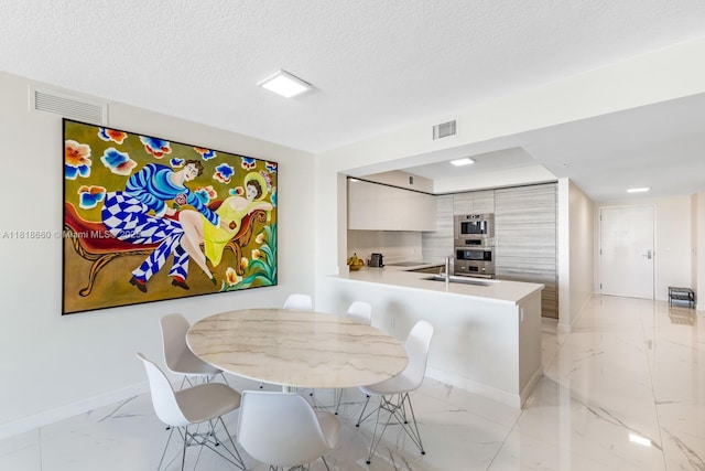 300 Sunny Isles Blvd Unit 4-2303, Sunny Isles Beach, FL 33160 - dining room featuring light marble finish flooring and a textured ceiling