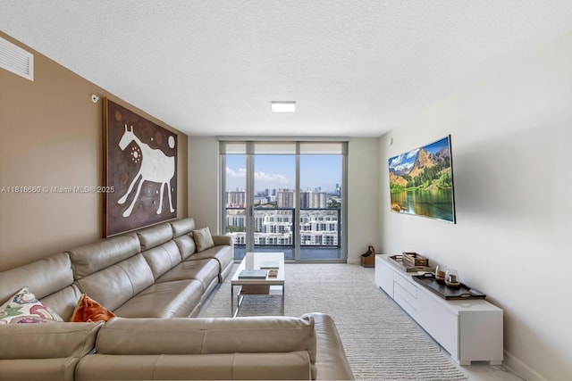 300 Sunny Isles Blvd Unit 4-2303, Sunny Isles Beach, FL 33160 - living room with expansive windows and a textured ceiling