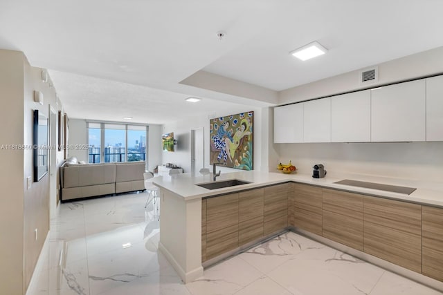 300 Sunny Isles Blvd Unit 4-2303, Sunny Isles Beach, FL 33160 - kitchen featuring light marble finish flooring, modern cabinets, open floor plan, and light countertops