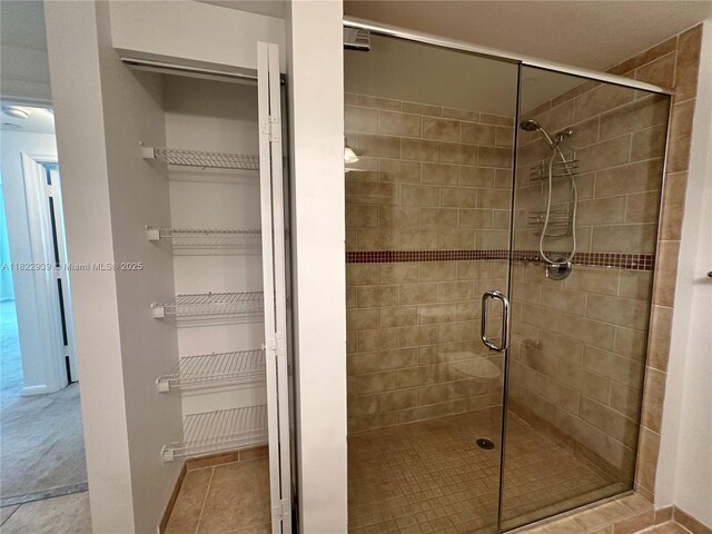 7350 SW 89th St Unit 602S, Miami, FL 33156 - full bathroom featuring a stall shower and baseboards