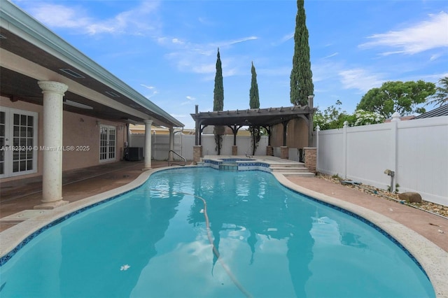 12440 SW 207th Ter, Miami, FL 33177 - view of pool featuring french doors, a fenced backyard, a patio area, and a pool with connected hot tub