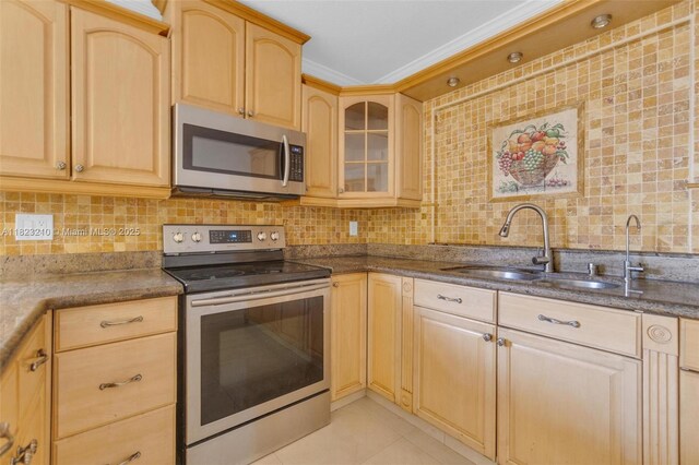 12440 SW 207th Ter, Miami, FL 33177 - kitchen with appliances with stainless steel finishes, light brown cabinetry, decorative backsplash, glass insert cabinets, and dark stone countertops