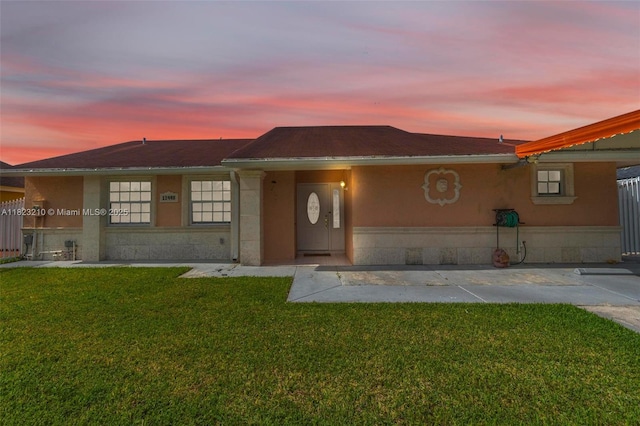 12440 SW 207th Ter, Miami, FL 33177 - view of front facade with a front yard and stucco siding