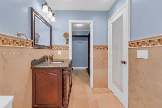 12440 SW 207th Ter, Miami, FL 33177 - bathroom with tile walls, vanity, a wainscoted wall, and tile patterned floors