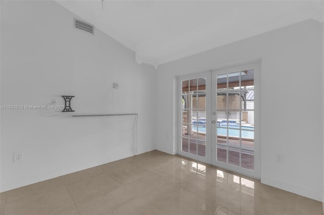 12440 SW 207th Ter, Miami, FL 33177 - spare room featuring french doors, tile patterned floors, and lofted ceiling