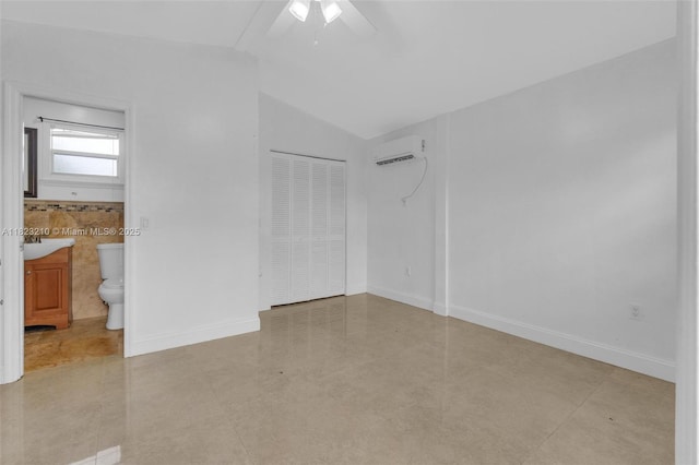 12440 SW 207th Ter, Miami, FL 33177 - unfurnished bedroom featuring a wall mounted air conditioner, lofted ceiling, a closet, ensuite bath, and a ceiling fan