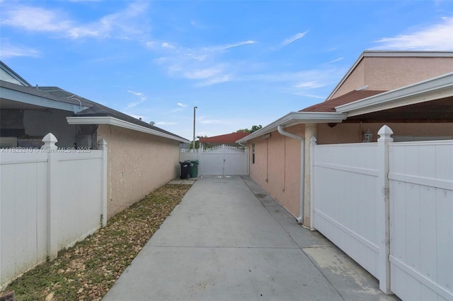 12440 SW 207th Ter, Miami, FL 33177 - view of property exterior with a gate and stucco siding
