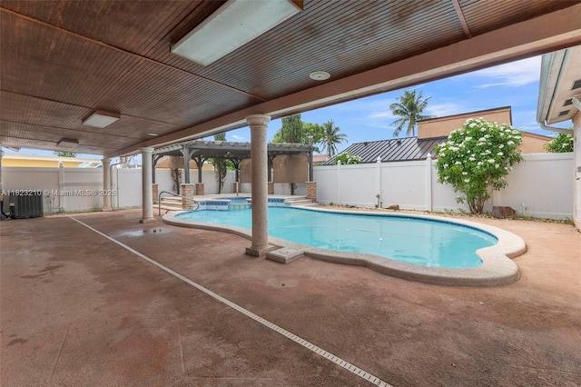 12440 SW 207th Ter, Miami, FL 33177 - view of pool featuring a patio area, a pool with connected hot tub, and a fenced backyard
