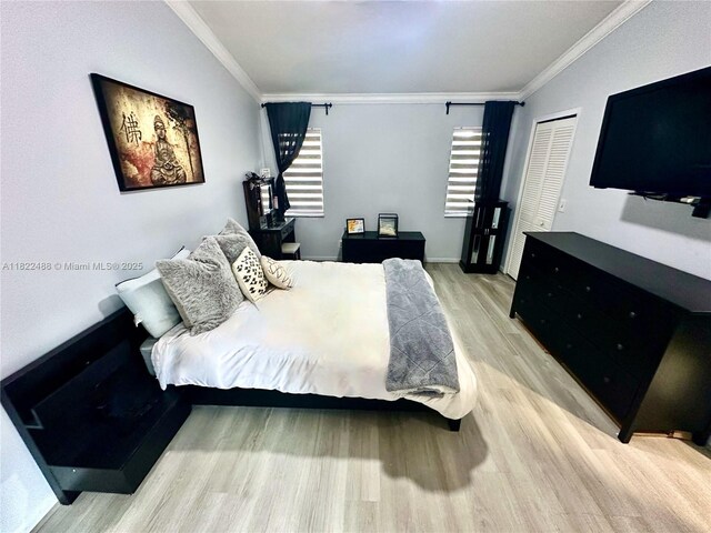 2433 NW 92nd Ave, Coral Springs, FL 33065 - bedroom with light wood finished floors, crown molding, and a closet