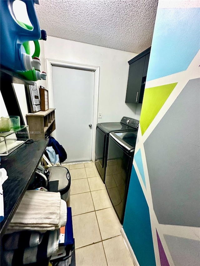 2433 NW 92nd Ave, Coral Springs, FL 33065 - laundry room featuring washer and dryer, cabinet space, light tile patterned floors, and a textured ceiling