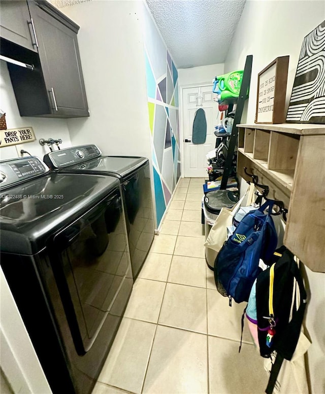 2433 NW 92nd Ave, Coral Springs, FL 33065 - laundry room featuring separate washer and dryer, a textured ceiling, cabinet space, and light tile patterned floors