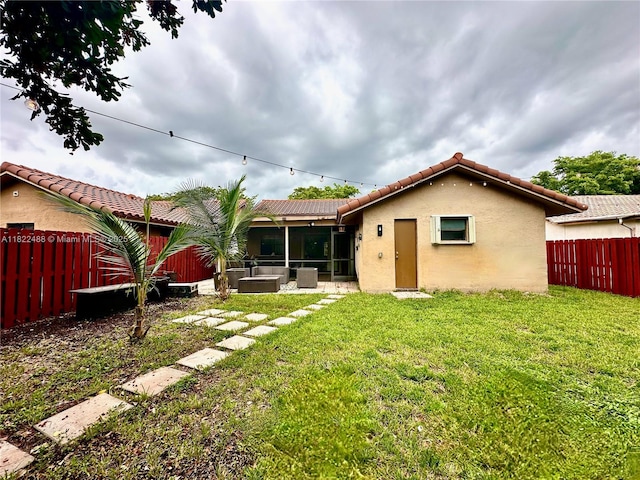 2433 NW 92nd Ave, Coral Springs, FL 33065 - back of property with stucco siding, a tiled roof, a sunroom, and a fenced backyard