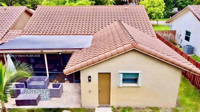 2433 NW 92nd Ave, Coral Springs, FL 33065 - rear view of house featuring a tiled roof, a patio area, an outdoor living space, and stucco siding