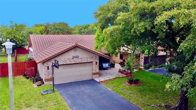 2433 NW 92nd Ave, Coral Springs, FL 33065 - view of front of property with a tiled roof, asphalt driveway, and a garage