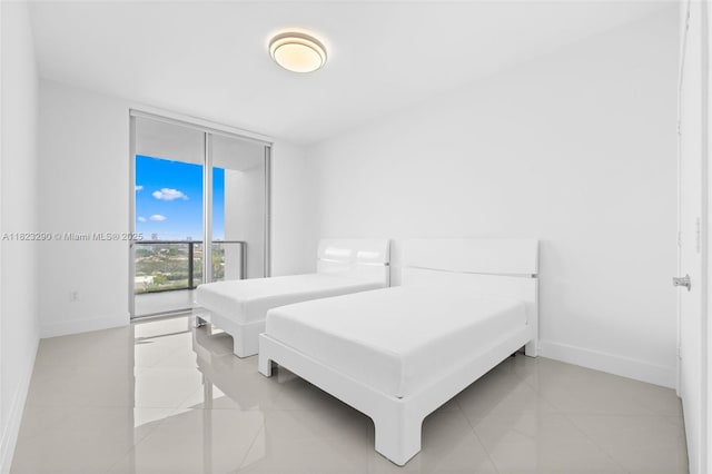 17301 Biscayne Blvd Unit 1704, North Miami Beach, FL 33160 - bedroom featuring floor to ceiling windows and light tile patterned floors