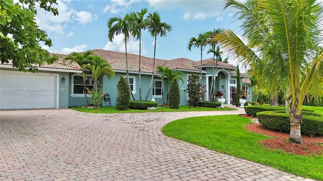 16541 SW 62nd St, Southwest Ranches, FL 33331 - view of front of property with curved driveway, stucco siding, and a garage