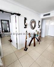 2910 Point E Dr Unit M610, Aventura, FL 33160 - corridor with ornamental molding and tile patterned floors