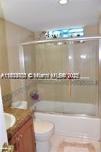 2910 Point E Dr Unit M610, Aventura, FL 33160 - full bath featuring vanity, bath / shower combo with glass door, and tile patterned floors
